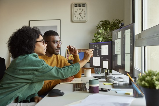 Man and woman examining computer screen