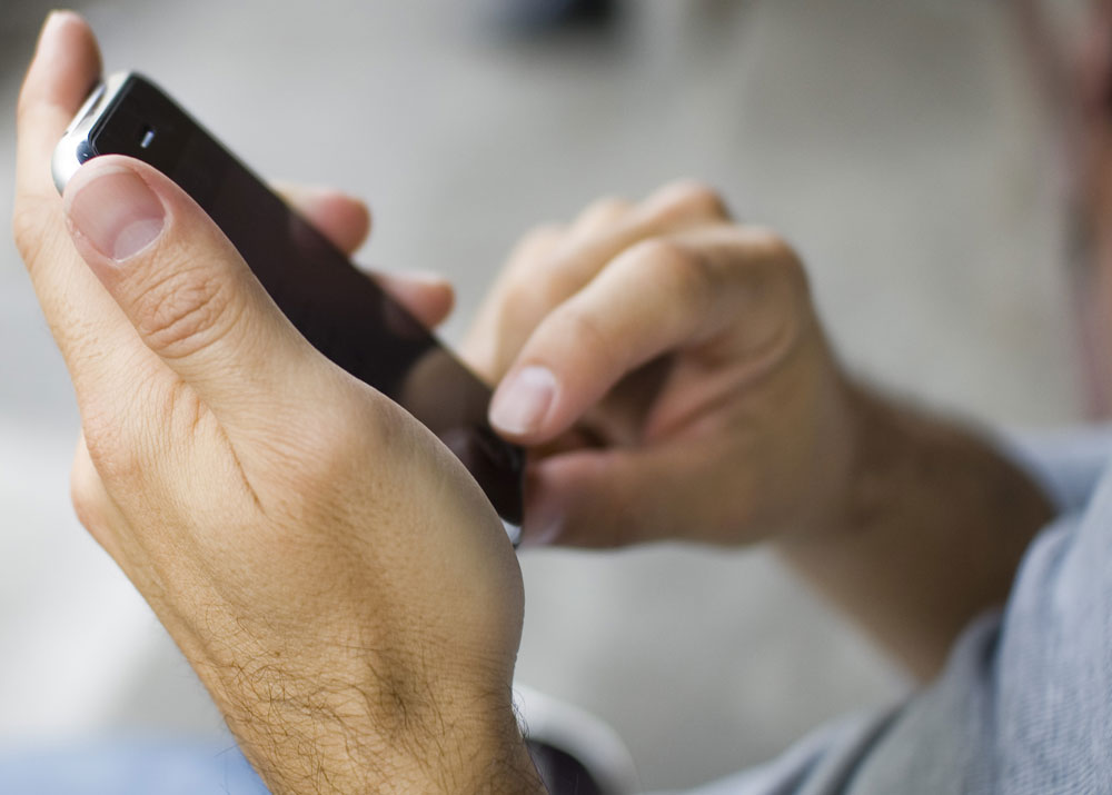 Close up of hands holding phone