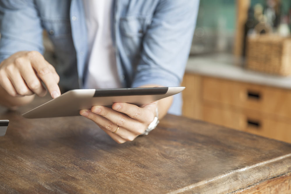 Person pointing at tablet screen